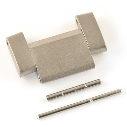 One TAG Heuer titanium bracelet link with original pin and tube on a white background